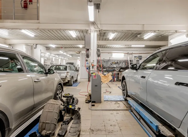 Bright, modern auto repair workshop with cars lined up in service bays